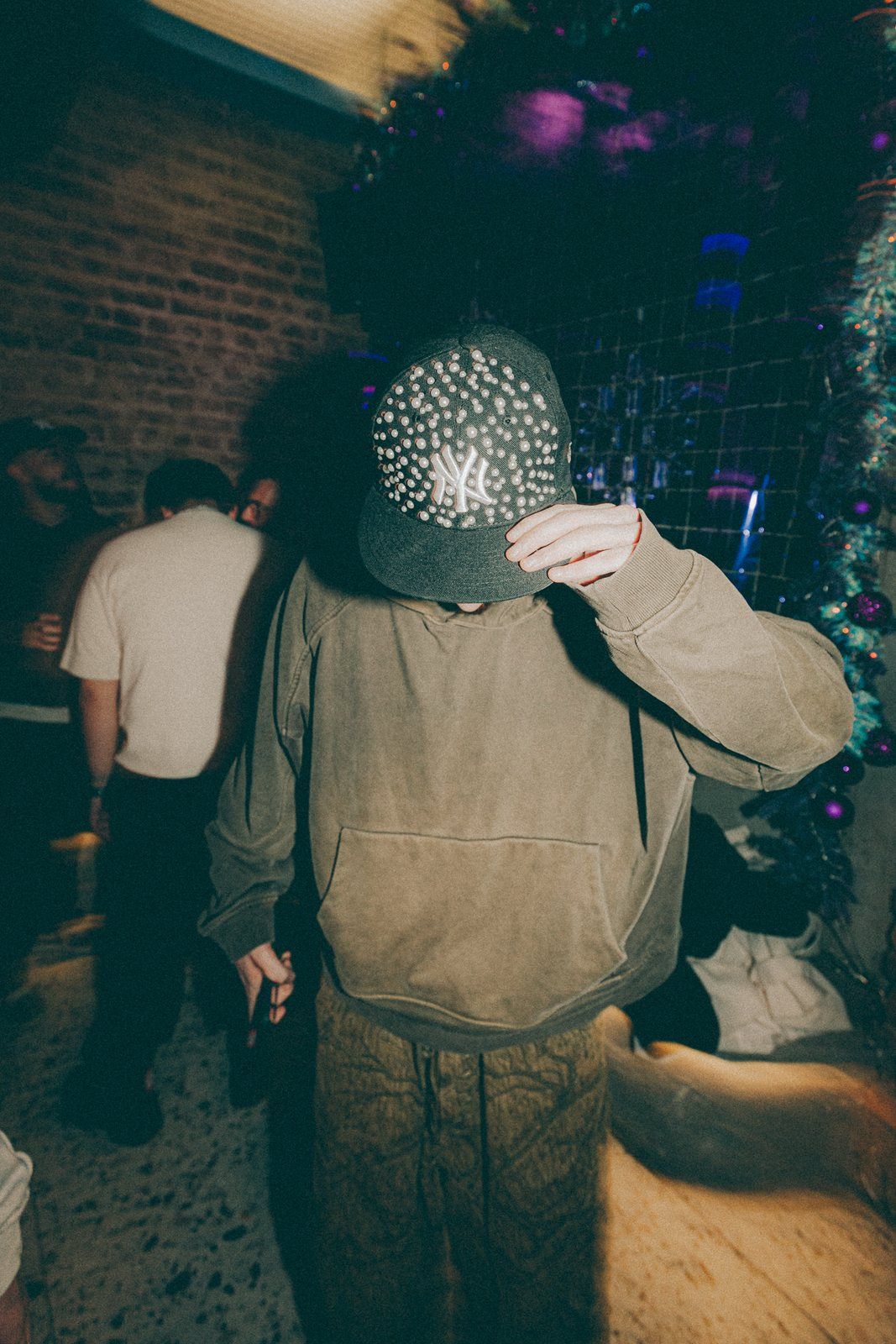 Pearl black cap worn at a party